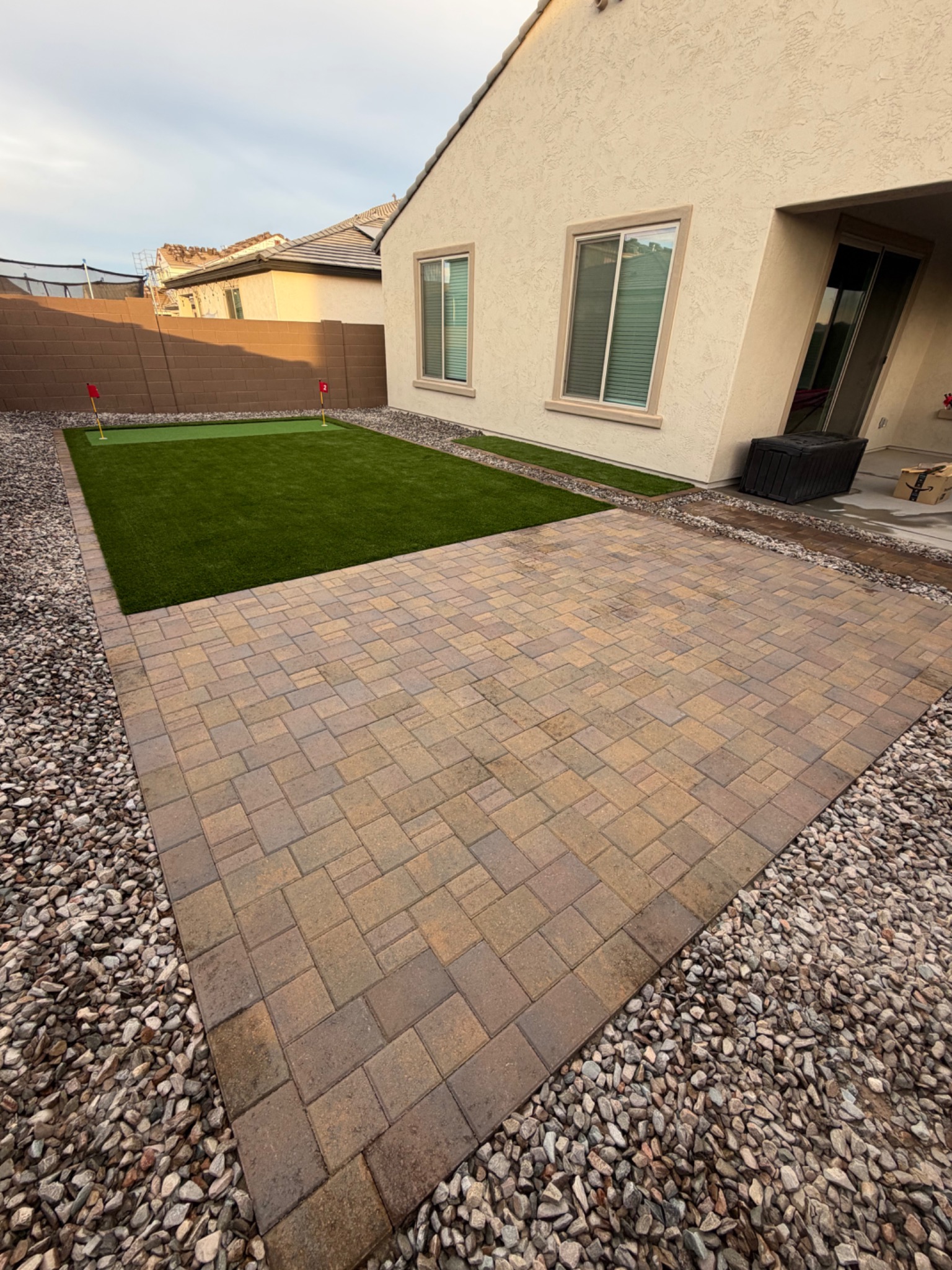 Completed paver and artificial turf landscape project
